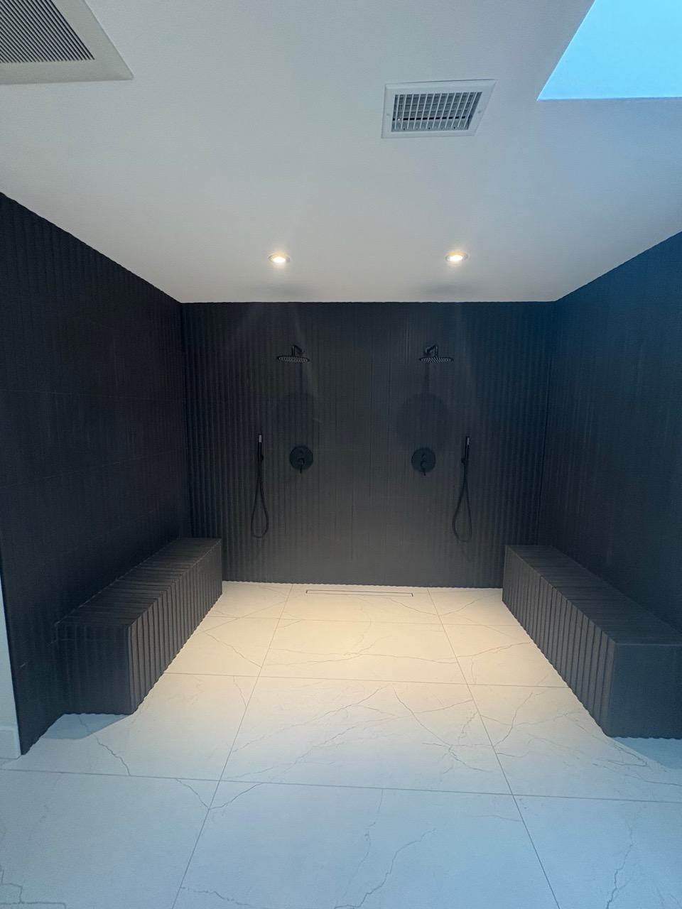 Bathroom remodel featuring updated shower and tile improvements