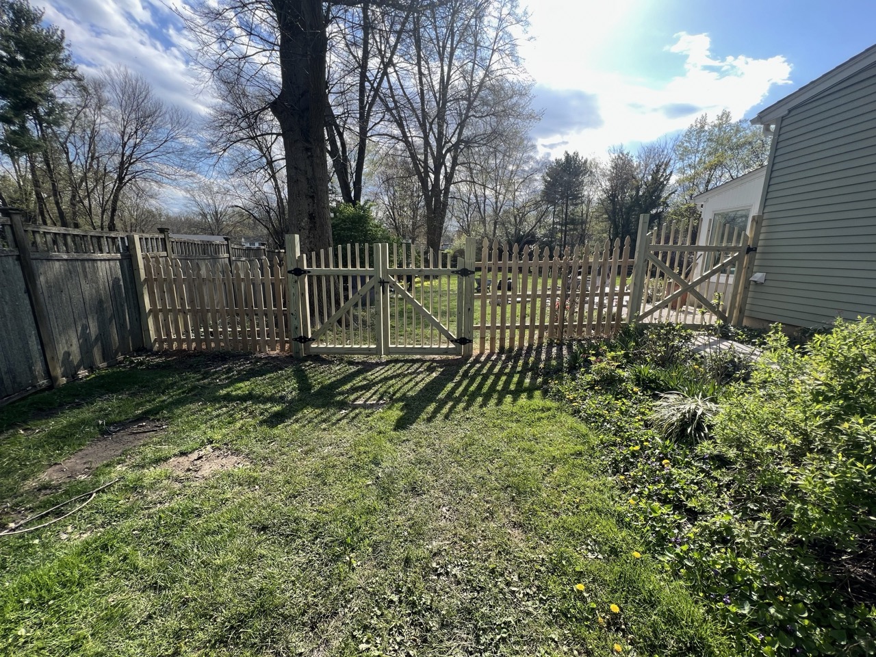 Fence renovation with new wood panels installed by Orion Remodeling & Handyman