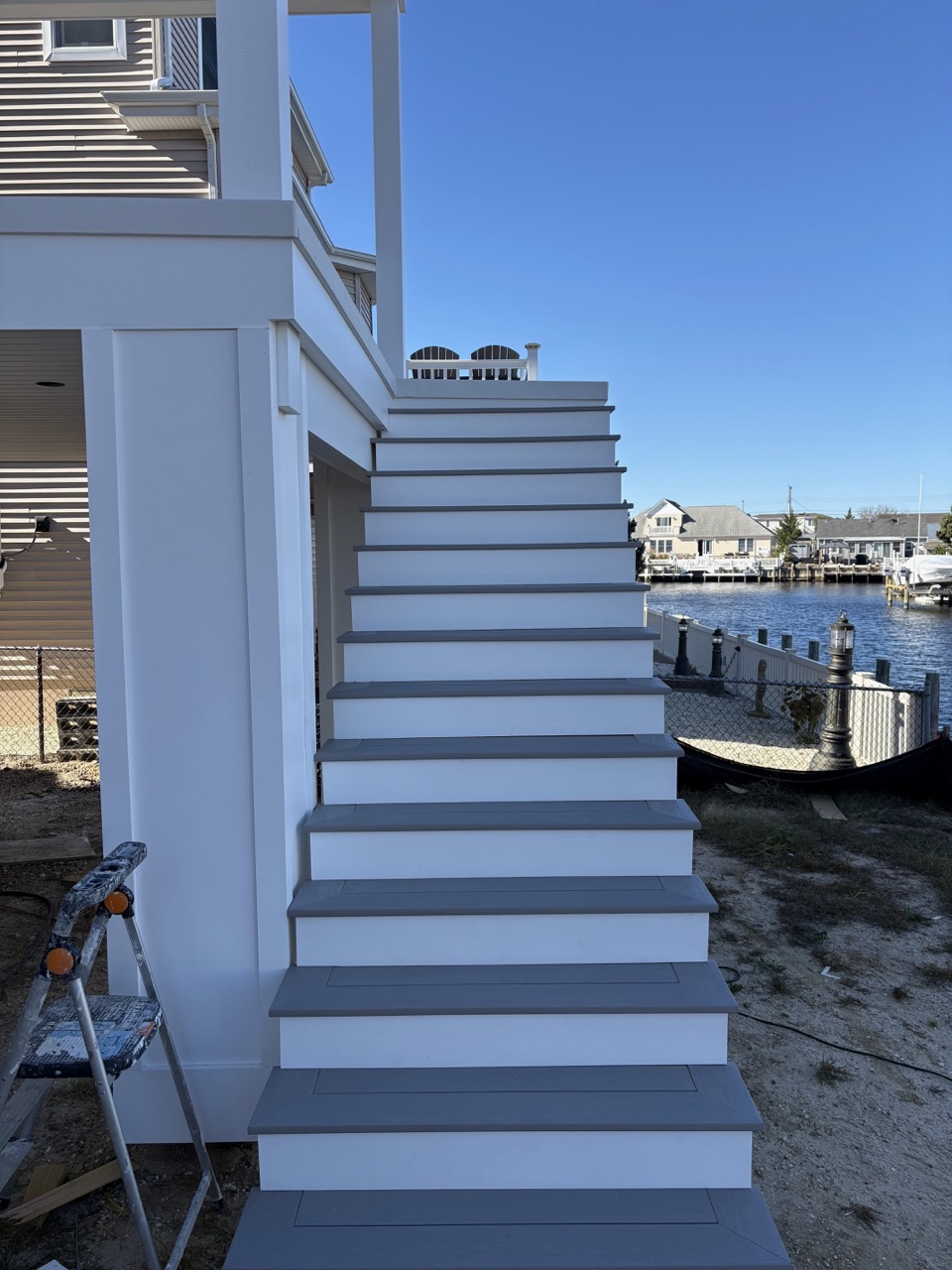 Staircase remodel showing new treads and refinished railing