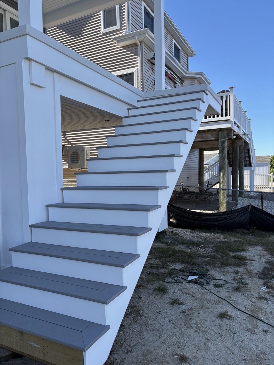 Staircase renovation featuring updated wood steps and railing